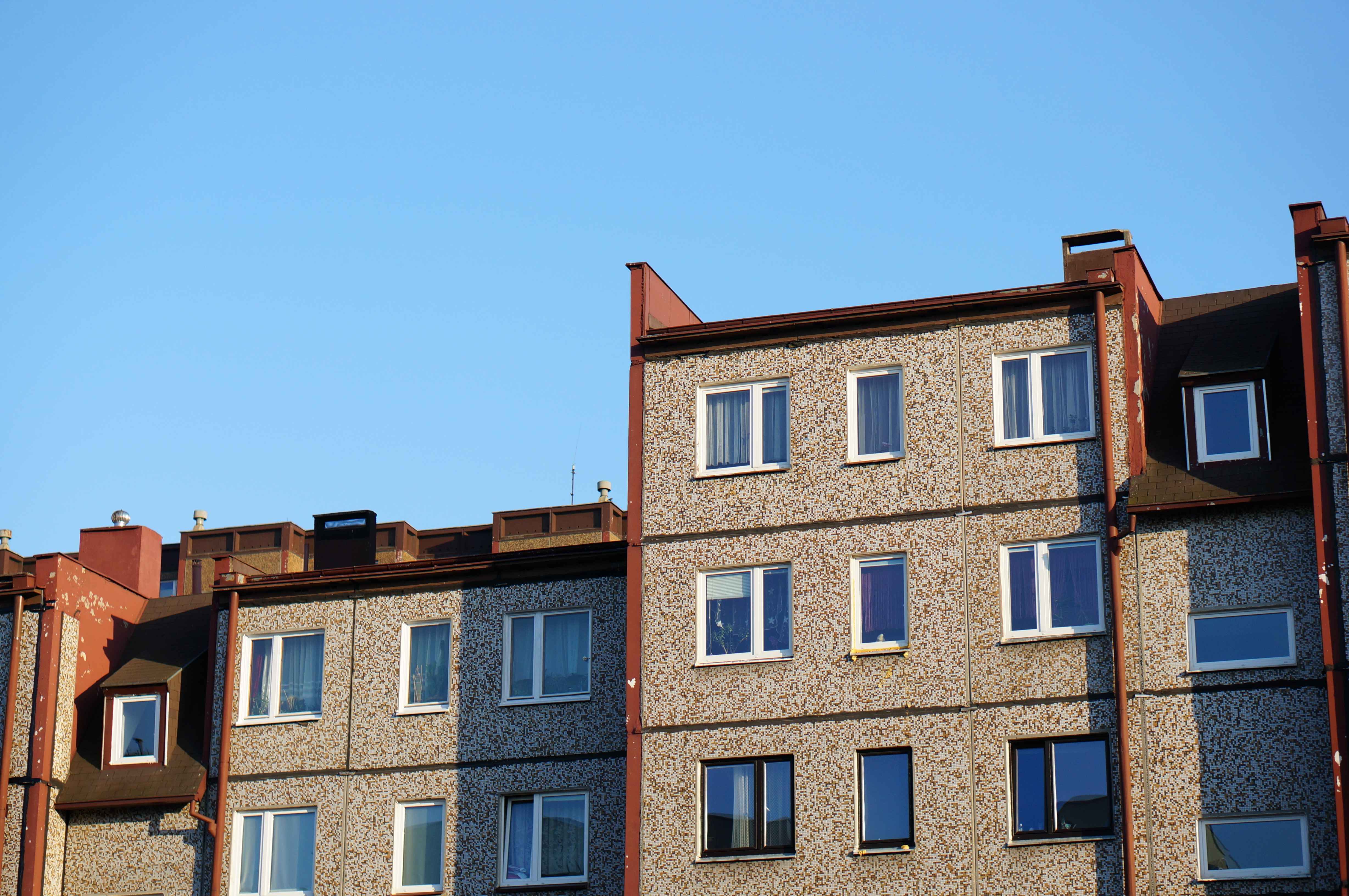 facade-row-apartment-buildings-against-clear-blue-sky_11zon.jpg
